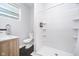 Clean bathroom with a modern vanity, black and white tiled floor, and a walk-in shower at 1009 Harrison St, Indianapolis, IN 46202