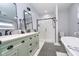 Modern bathroom featuring double sinks, marble countertop, elegant black hardware and glass shower at 1009 Harrison St, Indianapolis, IN 46202
