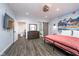 Spacious bedroom featuring vinyl flooring, a stylish dresser, and an inviting bathroom at 1009 Harrison St, Indianapolis, IN 46202