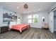 Inviting bedroom with modern lighting, a barn door and large windows offer ample natural light at 1009 Harrison St, Indianapolis, IN 46202