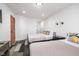 Bright bedroom features two beds with stylish pillows, modern lighting, and light-colored walls and floor at 1009 Harrison St, Indianapolis, IN 46202