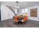 Dining area featuring a wooden table with bright orange chairs, located near the staircase at 1009 Harrison St, Indianapolis, IN 46202