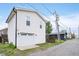This newly constructed home has an attached garage and a gravel driveway, showcasing modern architecture at 1009 Harrison St, Indianapolis, IN 46202