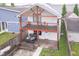 Charming two-story home featuring a balcony, patio, and outdoor dining area at 1009 Harrison St, Indianapolis, IN 46202