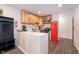 Kitchen with stainless steel appliances, marble countertops, light wood and white cabinets at 1009 Harrison St, Indianapolis, IN 46202