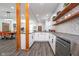 Modern kitchen featuring white cabinetry, stainless steel appliances, and open shelving at 1009 Harrison St, Indianapolis, IN 46202