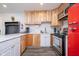 Kitchen with stainless steel appliances, marble countertops, and light wood cabinets at 1009 Harrison St, Indianapolis, IN 46202