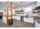 Modern kitchen featuring white cabinetry, stainless steel appliances, and open shelving at 1009 Harrison St, Indianapolis, IN 46202