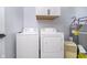 Practical laundry area equipped with a washer, dryer, and water heater for convenience at 1009 Harrison St, Indianapolis, IN 46202