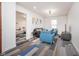 Living room with luxury vinyl plank flooring, sofa and armchairs and view of bedroom at 1009 Harrison St, Indianapolis, IN 46202