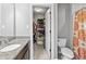 Inviting bathroom with granite countertop vanity that leads into a walk-in closet at 10504 Ruxton Ct, Fishers, IN 46040