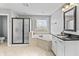 A modern bathroom featuring a walk-in shower, soaking tub, and vanity with granite countertops, creating a spa-like experience at 10504 Ruxton Ct, Fishers, IN 46040