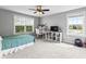 Bright bedroom with natural lighting, featuring a ceiling fan and a view of the neighborhood at 10504 Ruxton Ct, Fishers, IN 46040