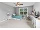 Bright bedroom with natural lighting, featuring a ceiling fan, desk and bookshelf at 10504 Ruxton Ct, Fishers, IN 46040