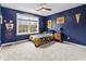 Bedroom with blue walls, ceiling fan, carpet, and a window for natural light at 10504 Ruxton Ct, Fishers, IN 46040