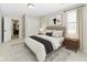 Relaxing bedroom with a neutral color palette, plush rug, and an inviting queen size bed, and natural light at 10504 Ruxton Ct, Fishers, IN 46040