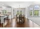 Open dining area connecting to kitchen, with hardwood floors and large windows for natural light at 10504 Ruxton Ct, Fishers, IN 46040