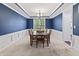 Beautiful dining room featuring blue walls, white trim, with a dining table set for a meal at 10504 Ruxton Ct, Fishers, IN 46040