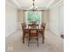 Elegant dining room with coffered ceilings, panelled walls, and a window offering ample natural light at 10504 Ruxton Ct, Fishers, IN 46040