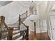 Inviting foyer with hardwood floors, elegant staircase, and beautiful architectural details at 10504 Ruxton Ct, Fishers, IN 46040