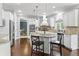 Bright kitchen with white cabinets, stainless appliances, and a breakfast bar with seating at 10504 Ruxton Ct, Fishers, IN 46040