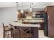 Basement kitchenette with granite countertops, dark wood cabinets, and barstool seating at 10504 Ruxton Ct, Fishers, IN 46040