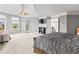 A spacious main bedroom offers a cozy seating area and features a ceiling fan for added comfort at 10504 Ruxton Ct, Fishers, IN 46040