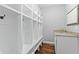 Functional mud room with built-in storage, hooks, and a granite countertop sink at 10504 Ruxton Ct, Fishers, IN 46040