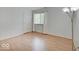 The bedroom has hardwood floors, a large window, and a stylish lamp at 1098 Timber Creek Dr # 2, Carmel, IN 46032
