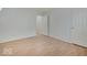 This bedroom has wood laminate floors, white trim, and a large window at 1098 Timber Creek Dr # 2, Carmel, IN 46032