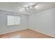 This bedroom features wood floors, neutral walls, and a sunny window at 1098 Timber Creek Dr # 2, Carmel, IN 46032