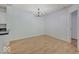Dining area with laminate flooring, white walls, modern lighting, and kitchen in the background at 1098 Timber Creek Dr # 2, Carmel, IN 46032