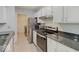 Well-lit kitchen boasts stainless steel appliances, granite counters, and white cabinetry at 1098 Timber Creek Dr # 2, Carmel, IN 46032