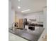 Bright kitchen featuring stainless steel appliances, granite counters, and modern fixtures at 1098 Timber Creek Dr # 2, Carmel, IN 46032