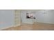 View of open living area showcasing laminate flooring and the kitchen featuring white cabinets at 1098 Timber Creek Dr # 2, Carmel, IN 46032