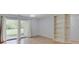 Spacious living room with wood floors, sliding glass doors to the patio, and a built-in bookcase at 1098 Timber Creek Dr # 2, Carmel, IN 46032