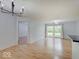 Open floor plan featuring wood floors, modern lighting, and sliding glass doors providing natural light at 1098 Timber Creek Dr # 2, Carmel, IN 46032