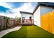 A compact backyard with a small deck and artificial turf provides a low-maintenance outdoor space at 1112 Spann Ave, Indianapolis, IN 46203