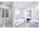 A modern bathroom featuring a walk-in shower, a freestanding tub, and double sinks at 1112 Spann Ave, Indianapolis, IN 46203