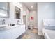 Modern bathroom with double sinks, framed mirrors, and a view into the toilet area at 1112 Spann Ave, Indianapolis, IN 46203