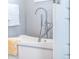 Modern bathtub with chrome fixtures and a handheld shower at 1112 Spann Ave, Indianapolis, IN 46203