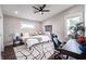 A bright bedroom with a ceiling fan, a desk, a large bed, and hardwood floors at 1112 Spann Ave, Indianapolis, IN 46203