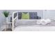 Close up of a nicely made white bed with a grey throw blanket in a bedroom with hardwood floors at 1112 Spann Ave, Indianapolis, IN 46203