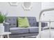Close up of a grey sofa with decorative mirror and plant in a bedroom at 1112 Spann Ave, Indianapolis, IN 46203
