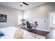 Spacious bedroom featuring a ceiling fan, a desk, a large bed, and hardwood floors at 1112 Spann Ave, Indianapolis, IN 46203