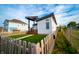 Modern home with a covered porch, fenced yard, and lush green lawn at 1112 Spann Ave, Indianapolis, IN 46203