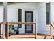 Welcoming front porch with modern furniture, wooden railing, and a sleek design at 1112 Spann Ave, Indianapolis, IN 46203