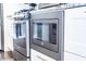 Close-up of stainless steel kitchen appliances including the oven, microwave, and stovetop at 1112 Spann Ave, Indianapolis, IN 46203