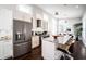 Modern kitchen with a large granite island, stainless steel appliances, and hardwood floors at 1112 Spann Ave, Indianapolis, IN 46203