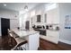 Bright kitchen with white cabinets, granite counters, stainless steel appliances, and island seating at 1112 Spann Ave, Indianapolis, IN 46203